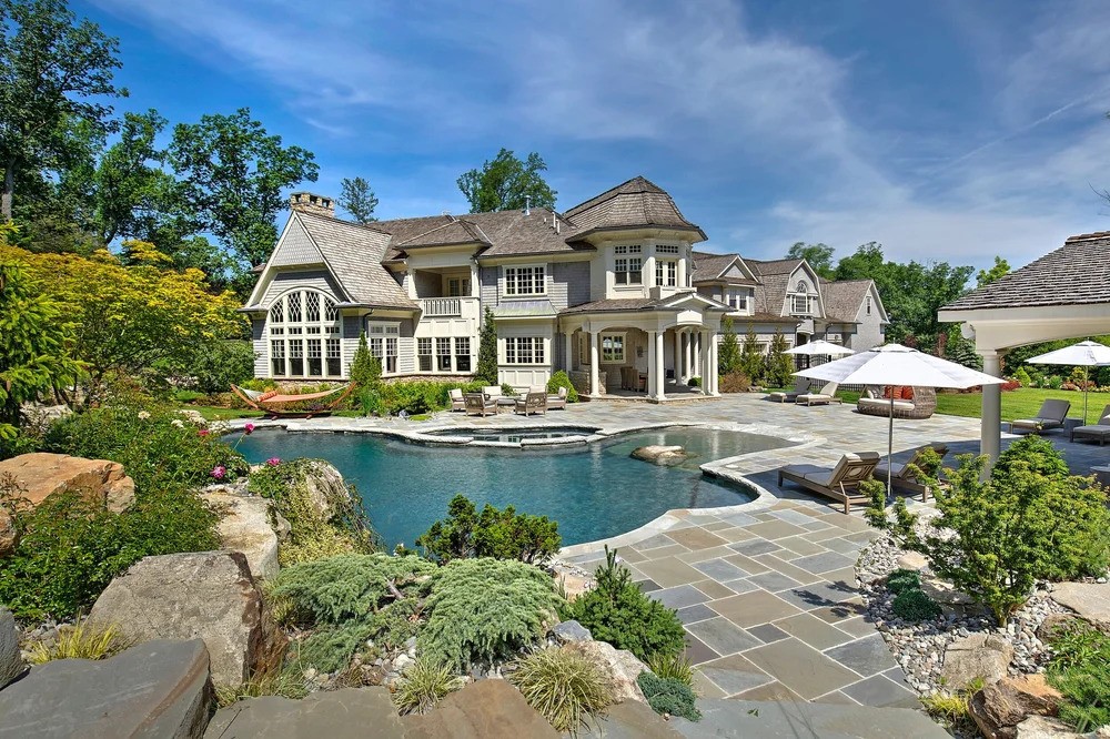 A spacious residence with a pool and patio area