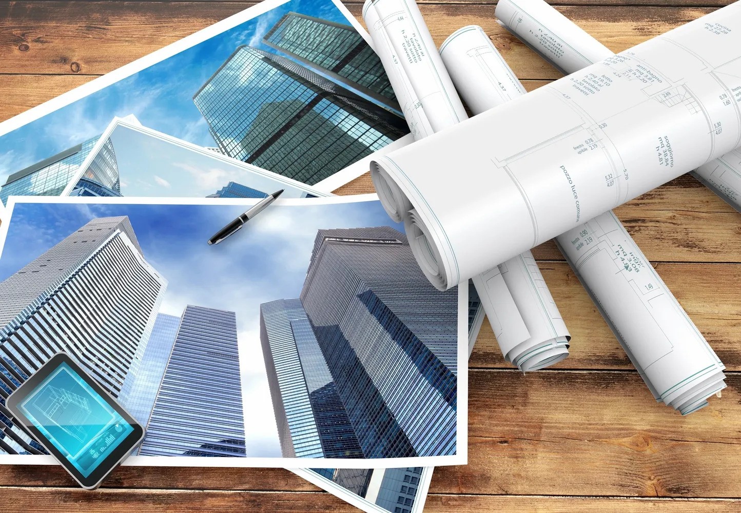 Architectural drawings and construction plans spread out on a wooden table