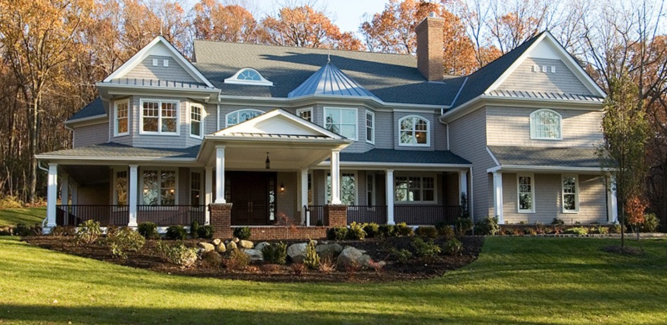 A large house surrounded by a spacious front yard